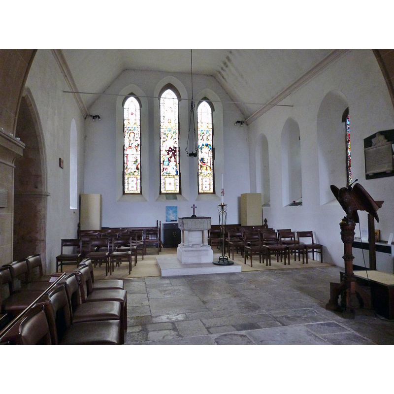 Source caption: "The Church of St Thomas a Becket, Pagham, West Sussex. The 19th century North transept housing a 12th century font consisting of square bowl of Purbeck marble on a stand with four corner shafts of a later date."