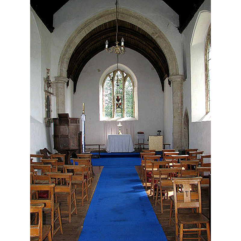 Source caption: "The church of All Saints - view east. The church is located in a meadow with only a couple of houses nearby. After the collapse of the tower, which took part of the nave with it, what remains of the building today is very small. The interior was extensively restored during the 19th century and only one window in the south chancel wall is still original, as is the bowl of the C13 Purbeck marble font. The pulpit dates from the 17th century."
