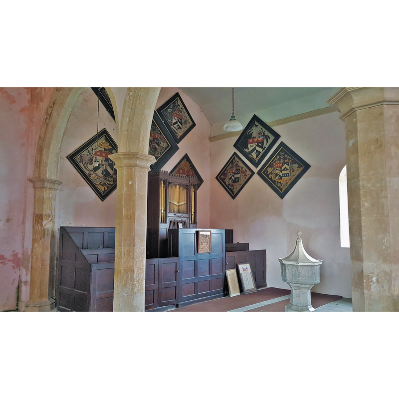 Source caption: "Church organ and heraldic plaques inside St Michael's Church, Benacre"