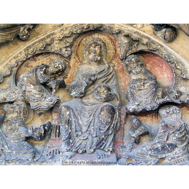 Source caption: "Saint-Pierre-le-Moûtier - Église Saint-Pierre - Portail latéral - Tympan" -- " Le tympan du porche de la porte Nord date de la fin du 12° siècle. Au centre, un christ bénissant est entouré du traditionnel tétramorphe :
en haut à droite, saint Jean et son aigle
en haut à gauche, saint Matthieu, l'homme ailé écrivant son évangile
en bas à droite, saint Luc et son boeuf,
en bas à gauche, saint Marc et son lion."