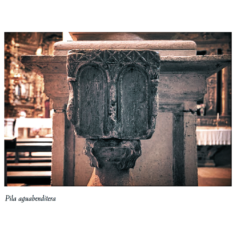 Source caption: "Frente a la puerta de la entrada y adosada a la columna del segundo tramo hay un pila aguabenditera románica. Es de piedra caliza y está decorada en tres de sus caras con dobles arcos de medio punto que llevan tallado en sus enjutas un motivo triangular." -- the holy-water stoup in context seen here before it was caged in the present frame