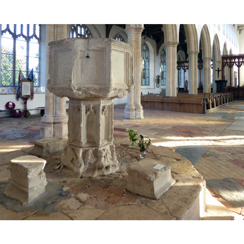 Source caption: "The font in Holy Trinity Church, Blythburgh [...] The font dates from 1449 and has an inscription commemorating John Mason and his wife."