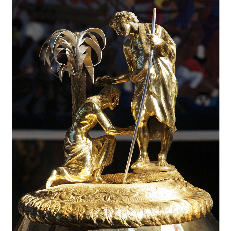 Source caption: "Der Deckelschmuck des Taufsteins der Pfarrkirche St. Mauritius in Appenzell. Der Runddeckel auf dem Taufstein aus dem 17. Jahrhundert, endstand im 1. Viertel des 19. Jahrhunderts. Er besteht aus teilweise vergoldetem Kupfer."