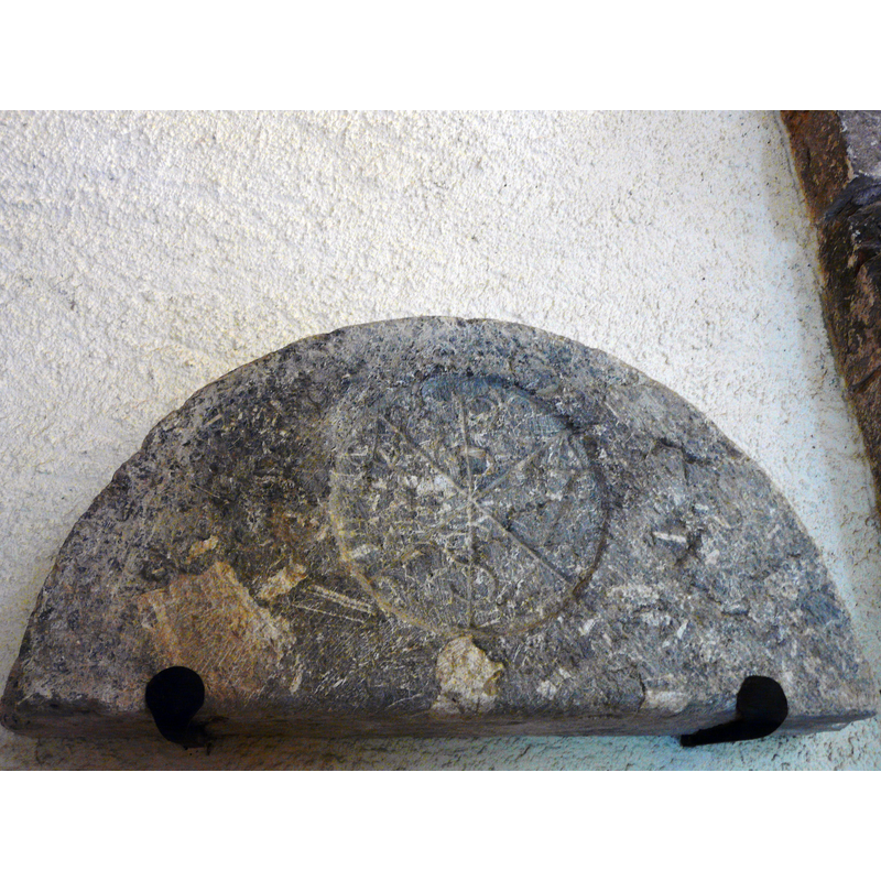 Source caption: "Chrisme à l'intérieur de l'église Saint-Barthélémy, Bramevaque, Hautes-Pyrénées, France." [NB: this stone appears to have been a tympanum originally but it is now fully detached and just mounted on the north wall of the nave]