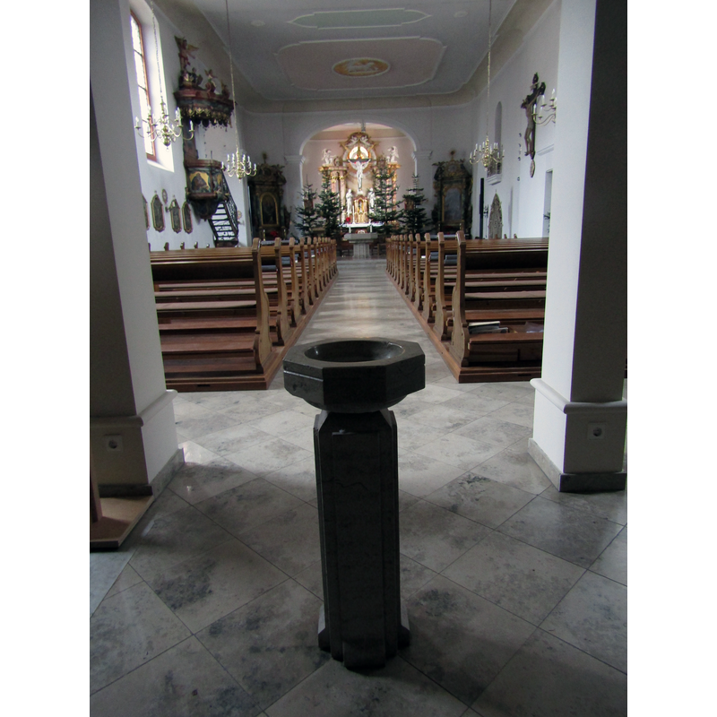 showing a modern holy-water stoup in the forreground