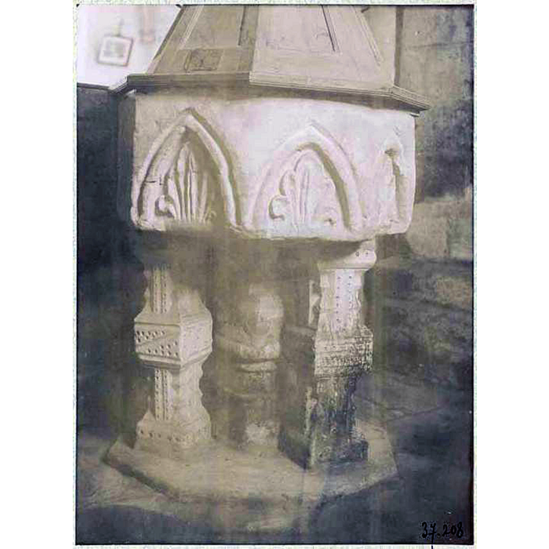 view of the 14thC(?) font showing the 18thC wooden cover partially