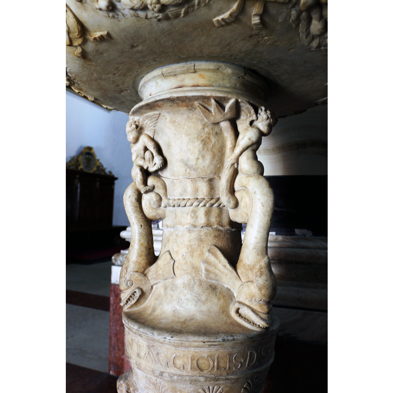 Source caption: "Scuola di antonio federighi, acquasantiera del duomo di grosseto, 1506" -- showing two of them here, sitting on the tail of the tritons