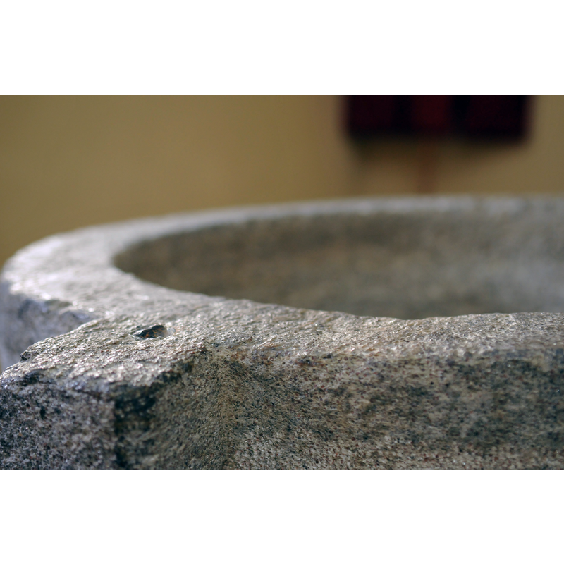 Source caption: "Kath. Pfarrkirche St. Nikolaus. Detail Taufbrunnen" -- the lead(?) plugin the stone is probably an anchoring spot for an earlier cover