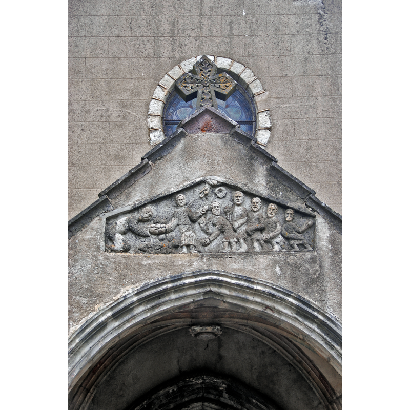Source caption: "Dorflirche Chambon-sur-Lac, Relief, Steinigundg des Stephanus" -- the re-used tympanum featuring the martyrdom of St Stephen is mounted on the west side of the church, on the porch, not on the portal itself