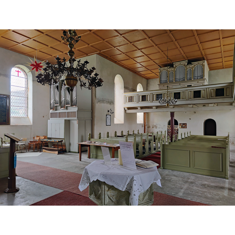 Source caption: "Evangelische Dorfkirche Rohrberg, Altmarkkreis Salzwedel, Sachsen-Anhalt, Deutschland" -- showing the post-Reformation font in the foreground