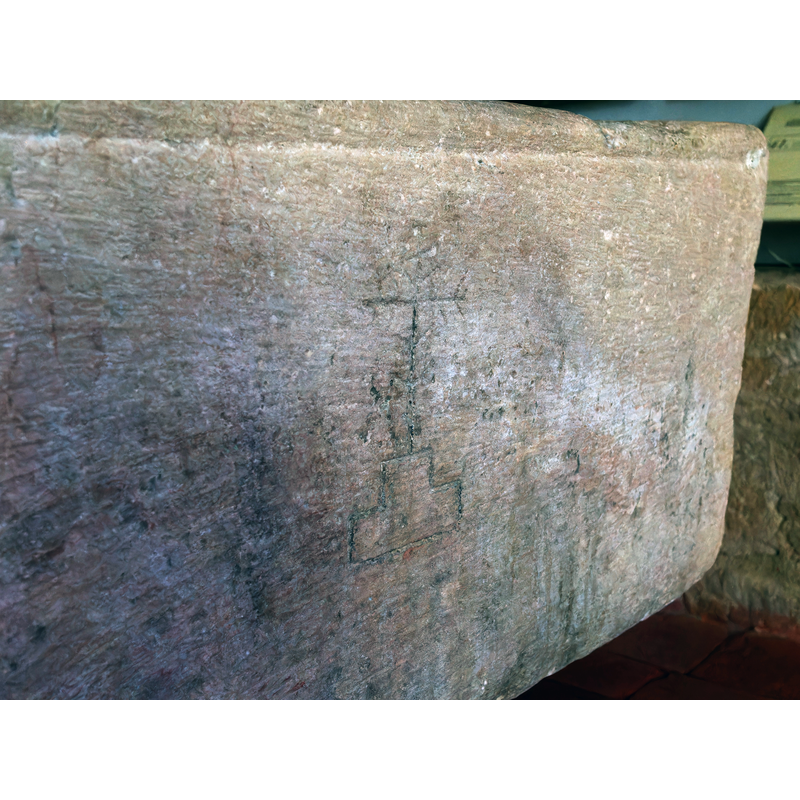 on two of the sides; the one on this side is quite faintly incised and may have been a later addition