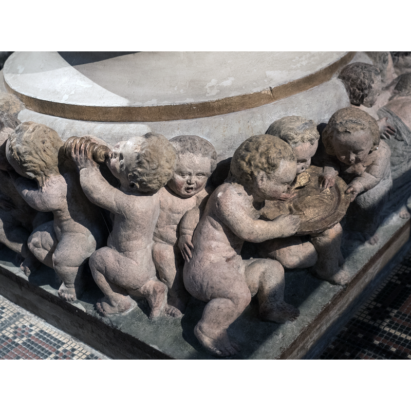Source caption: " Fuß des Taufsteines der Marienkirche zu Pirna von 1561, Christoph Kramer aus Dresden zugeschrieben" -- children, some dressed, some naked; they hug, eat, drink, look at each other, play with animals, sleep, etc.