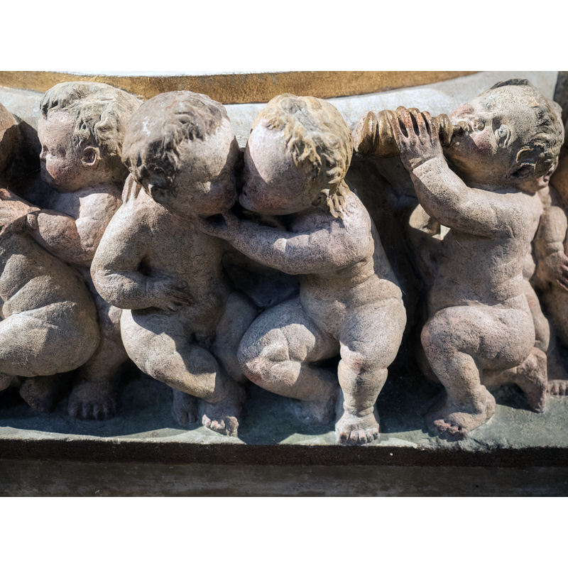 Source caption: " Fuß des Taufsteines der Marienkirche zu Pirna von 1561, Christoph Kramer aus Dresden zugeschrieben" -- children, some dressed, some naked; they hug, eat, drink, look at each other, play with animals, sleep, etc.