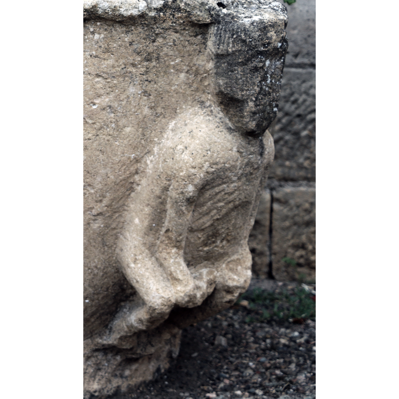 showing one of the crouching or sitting figures