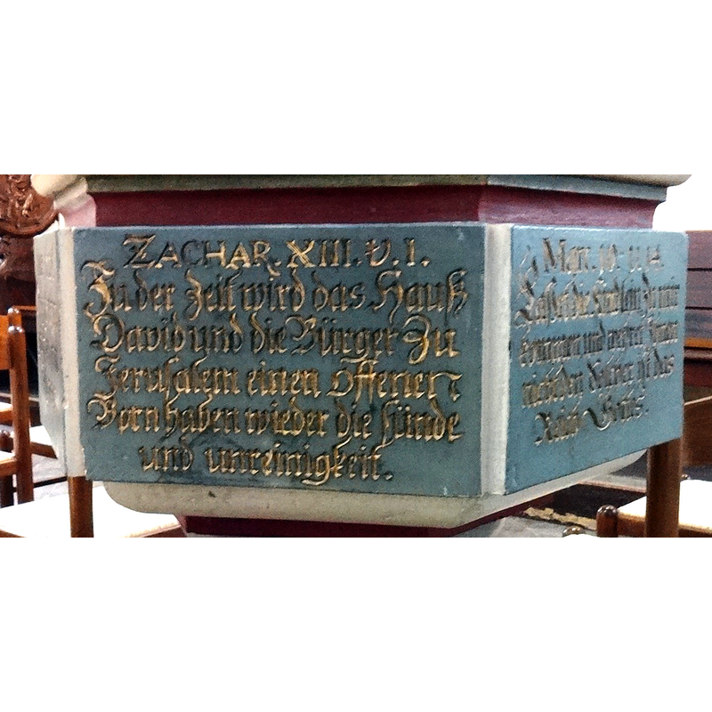 a biblical quotation on each side of the hexagonal basin