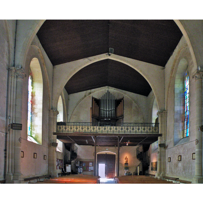 Source caption: "Église Sainte-Suzanne de Sainte-Suzanne (Mayenne)" -- the top of the baptismal font and its cover may be discerned at the far [west] end, just left [south] of the stairwell leading to the gallery