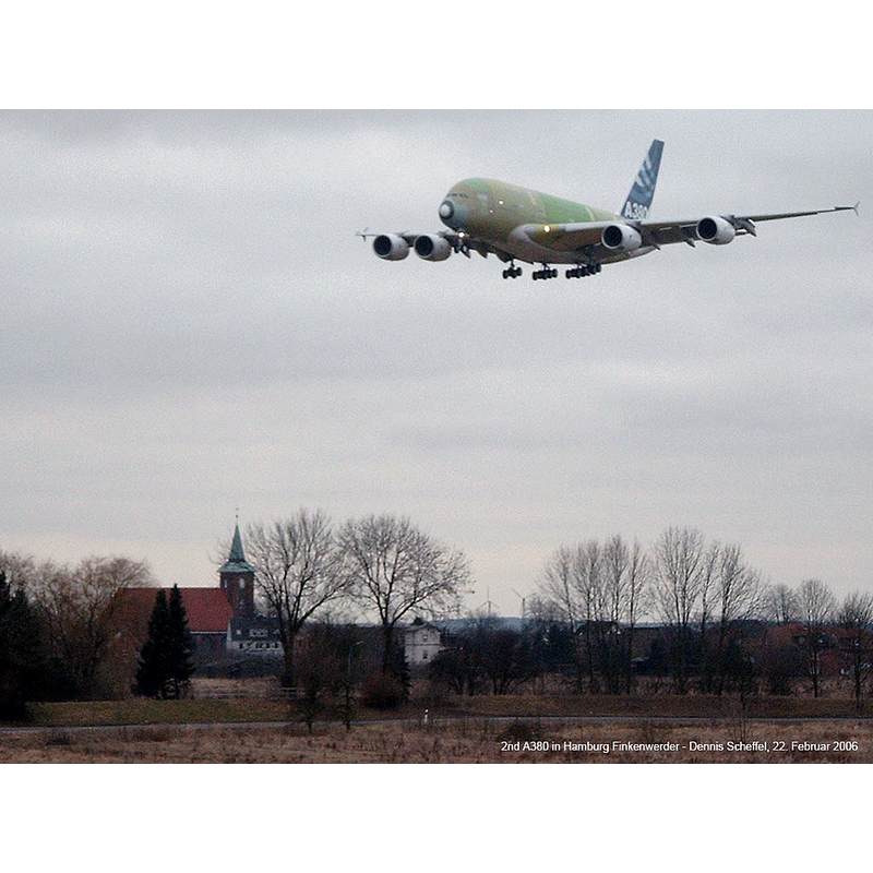 Source caption: "Ein Airbus A380 über Hamburg-Neuenfelde. Die Maschine befindet sich im Anflug auf den Flugplatz Hamburg-Finkenwerder. Im Hintergrund die Kirche von Neuenfelde."