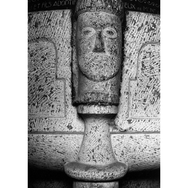 one of the four heads from the medieval font now built into the 1920s font