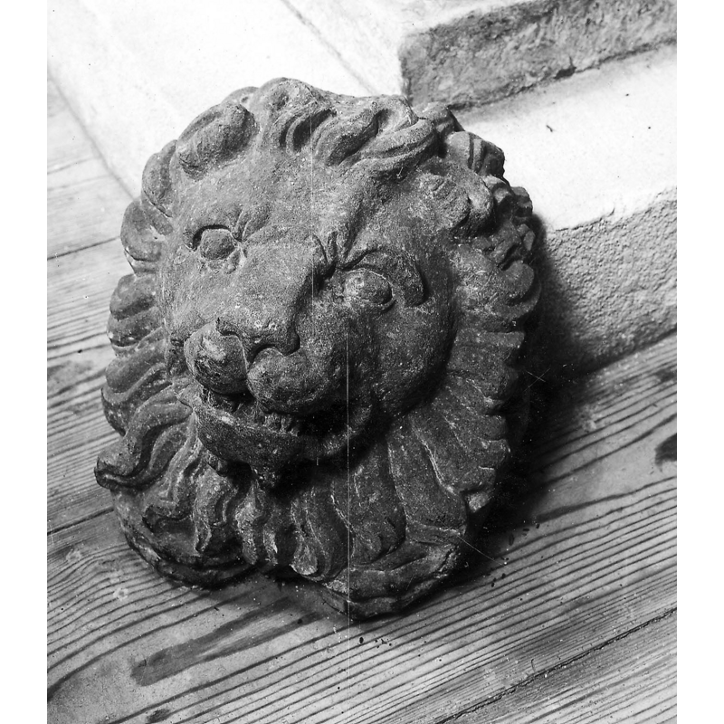 the lion head shown here and three others were not originally part of the lower base and were later removed