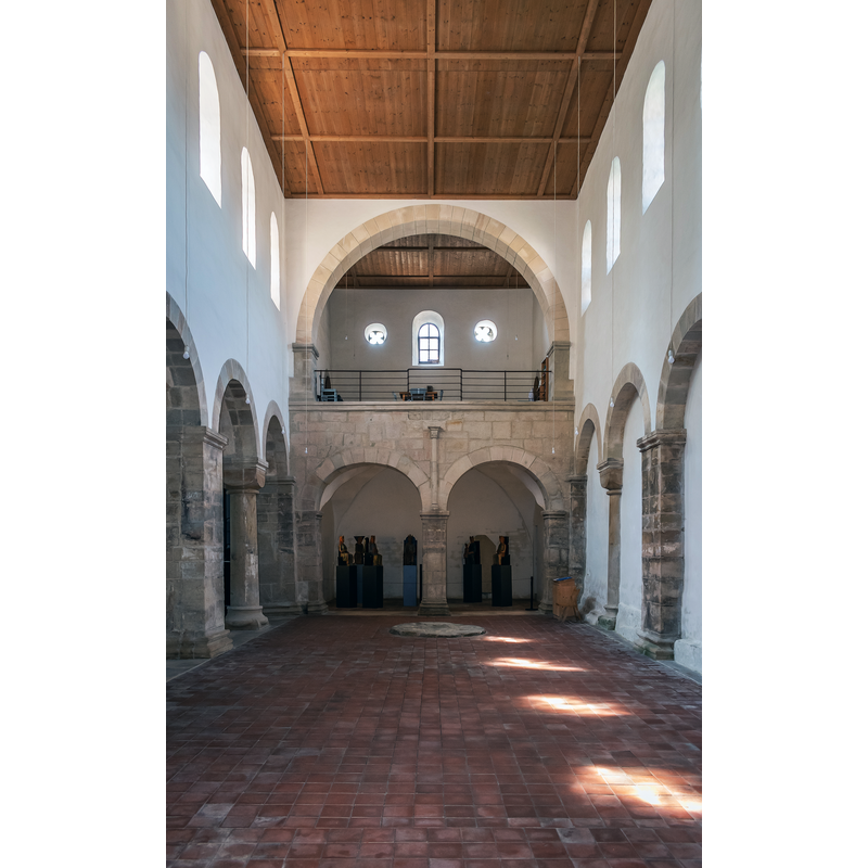 Source caption: "Interior of the Saint Thomas of Canterbury church in Merseburg, Saxony-Anhalt, Germany" -- is the circular item on the ground the former plinth of the medieval font now in the cathedral?