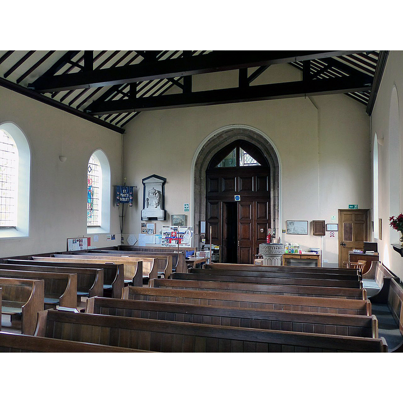 Source caption: "Church of St Mary, Bosley. The nave looking west. The tower arch is clearly the original of the 16th century." -- showing the modern font at the back