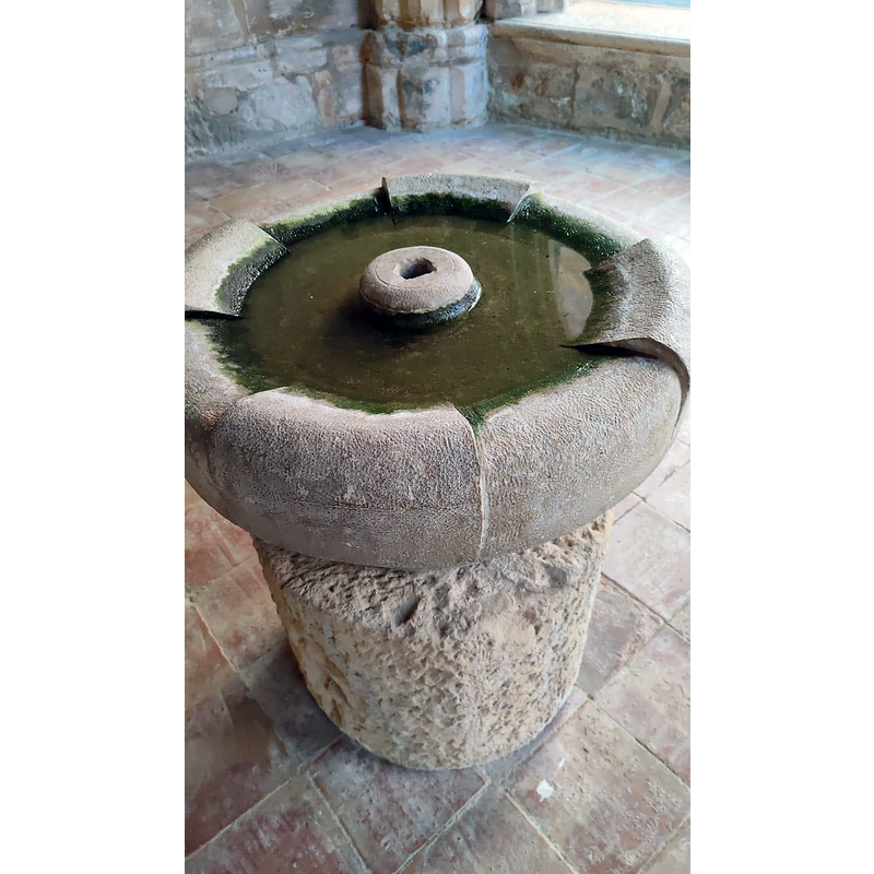 a fountain? the base appears to have been re-purposed from whatever it was originally