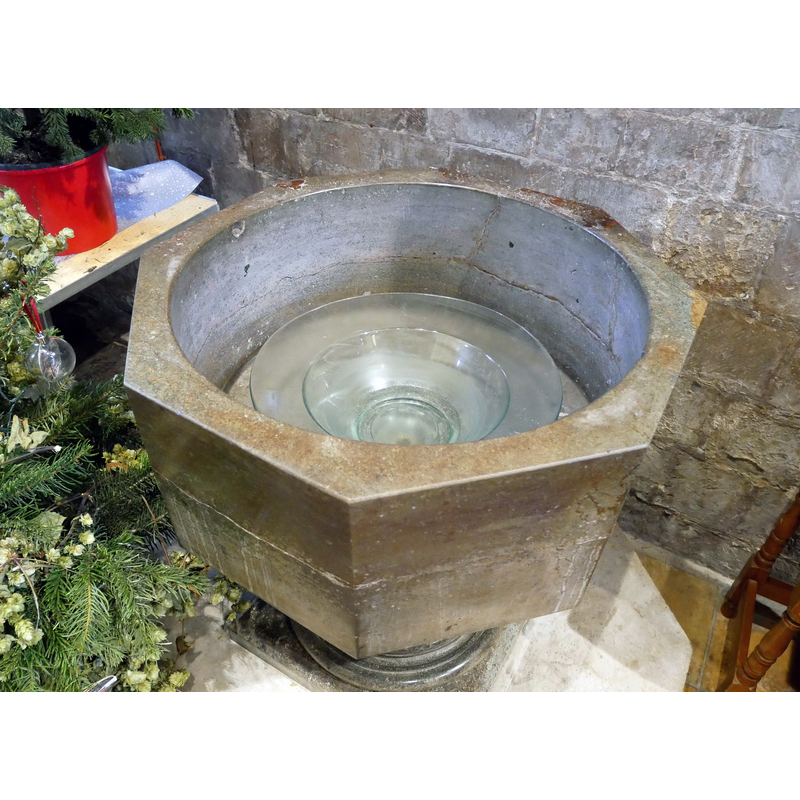 Source caption: "The 12th-century purbeck marble baptismal font by the west entrance of Waltham Abbey Church in Essex."