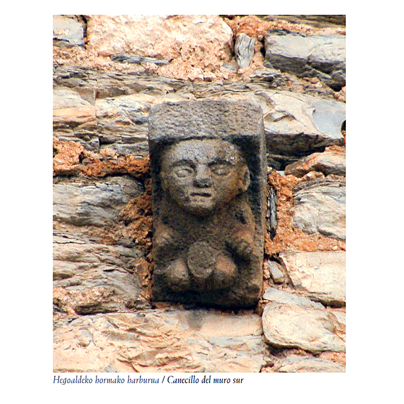 Source caption: "Todos los canecillos son lisos, a excepción de uno que representa la figura de un hombre, de rasgos faciales muy marcados, en particular los ojos y la boca. Abre los brazos y se encoge de piernas. Todo ello es de reducidas dimensiones en comparación con lo desproporcionado del sexo, que se halla mutilado, por lo que lo calificamos como exhibicionista." -- re-mounted corbel from an earlier church