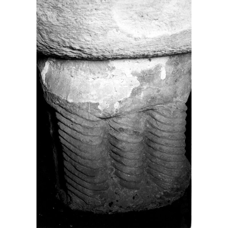 Source caption: "Detalle del pie cuadrangular de la pila bautismal; presenta tres columnas torsas" -- the base is made up of twelve clustered colonnettes, thre of which are torsade; the rest are plain