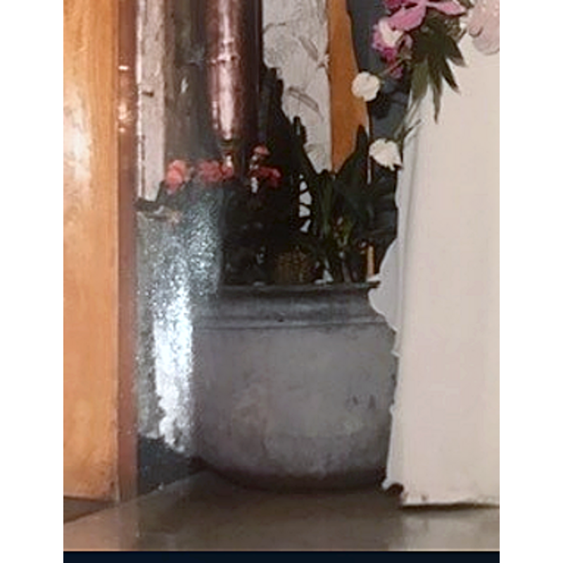 "There was no support of the baptismal font, because the basin was bricked into the wall. Mia [...] sent me a wedding picture of her standing next to the baptismal font used as a flower pot."