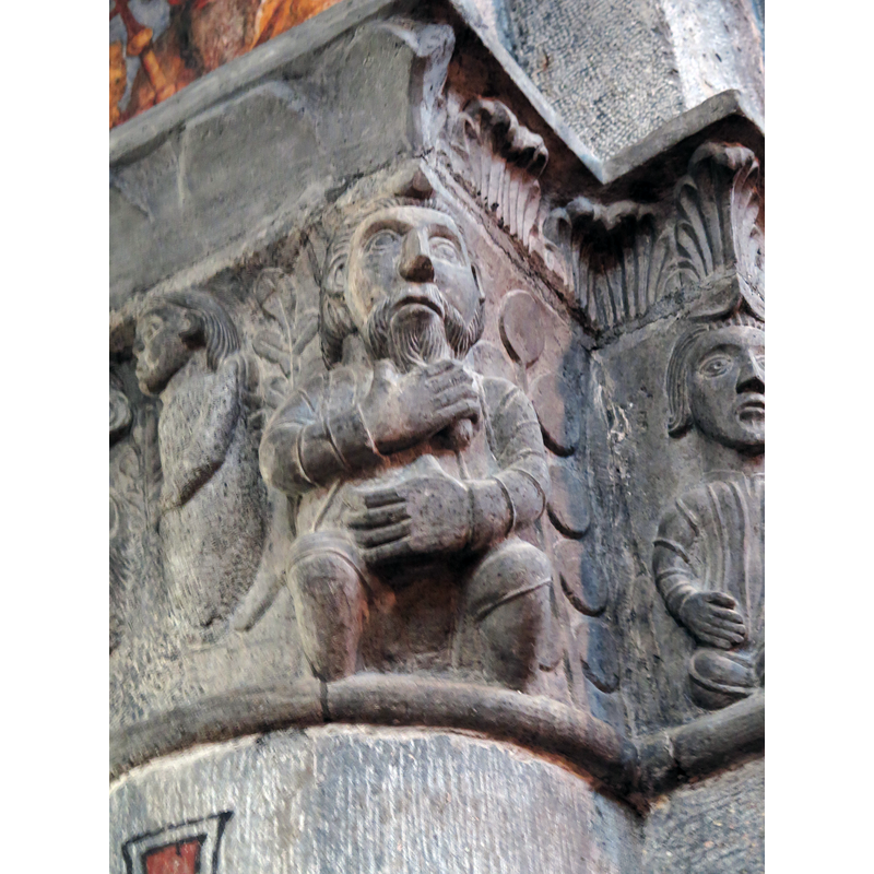 Source caption: "Ein Mann schwört zu fremden Göttern oder führt Gottes Namen unnütz im Munde. Kathedrale Chur, östliche Säule auf der Nordseite des Langhauses. 1. Hälfte 13. Jahrhundert."