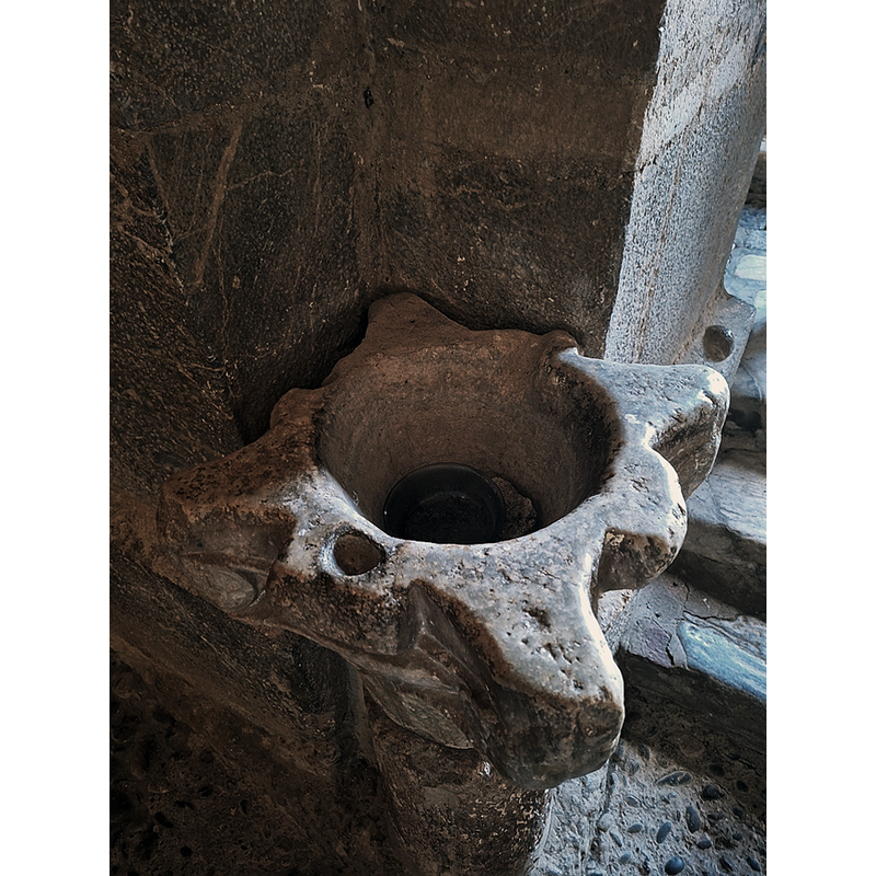 One of two former Romanesque capitals re-purposed as holy-water stoups and located by the entranceway