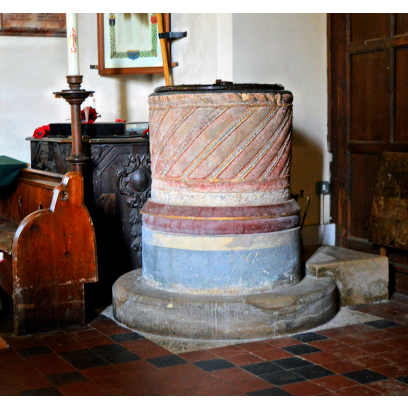 Source caption: "St Margaret, Mapledurham. The Norman tub font, decorated in West Ham United colours by William Butterfield around 1863."