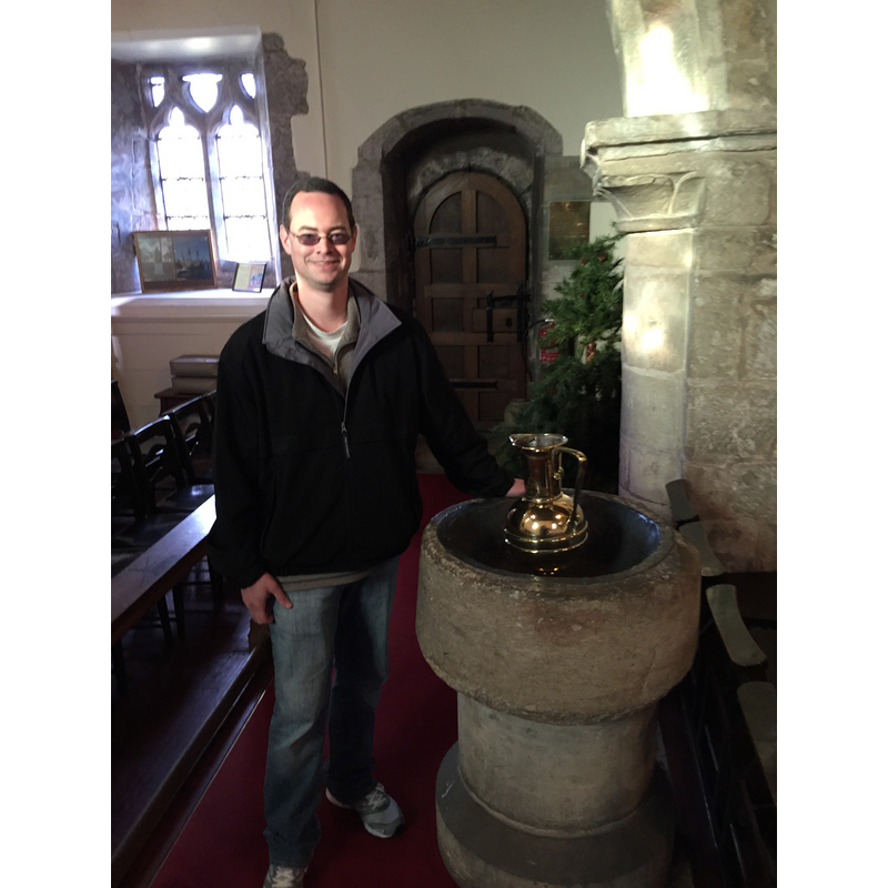 Source caption: "Inside the church, the original baptismal font is still present, where the infant William Bradford was baptized on 19 March 1589/90."