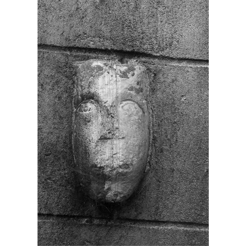 fragment from a medieval font, now wall-mounted on the north wall of the sacristy [cf. FontNotes]