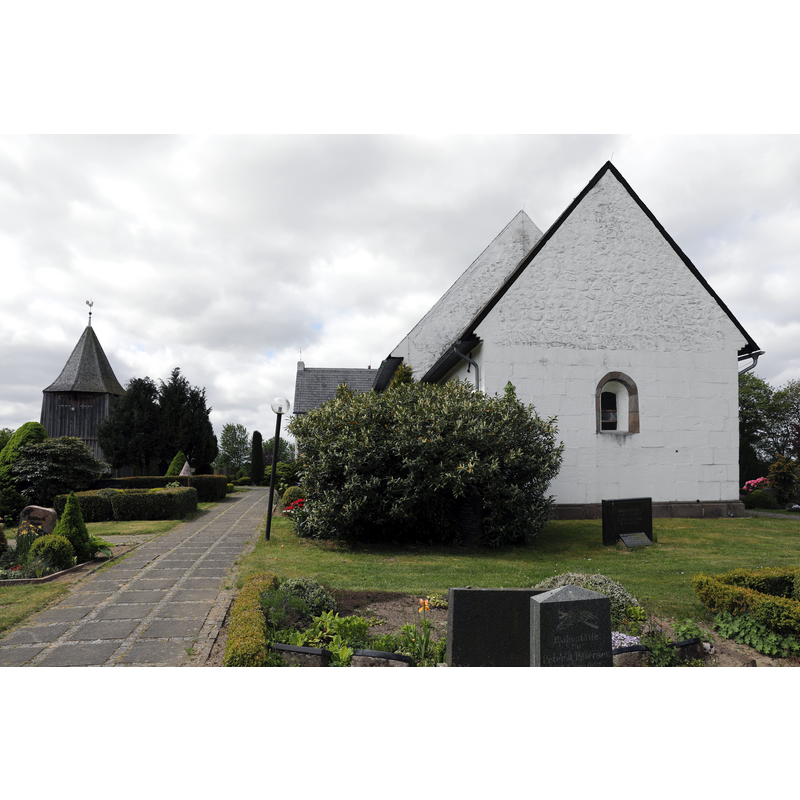 the detached bell tower on the left of the image