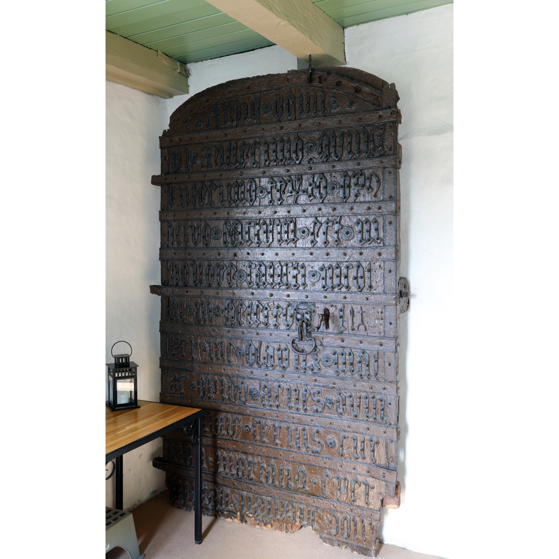the ancient door is now installed as a decoration inside the porch