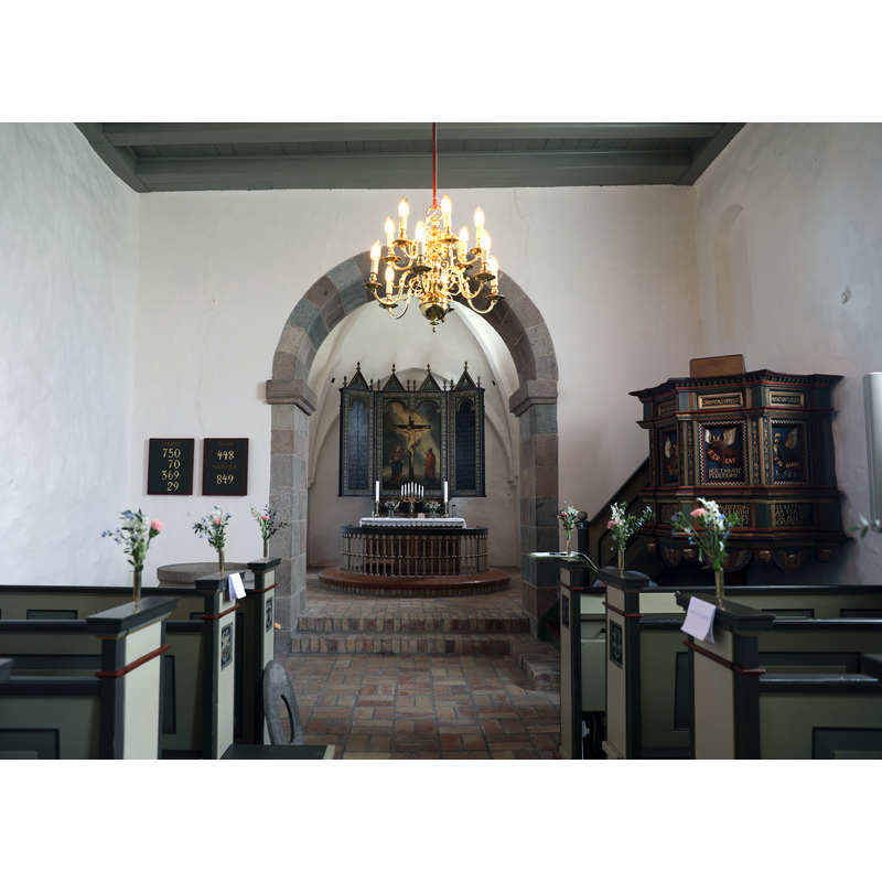 the top of the font is discernible on the left of the image, in front of the left row of pews