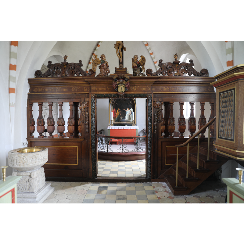 showing the medieval font in the foreground, on the left, and the magnificent Korskranke [chancel screen] of 1695