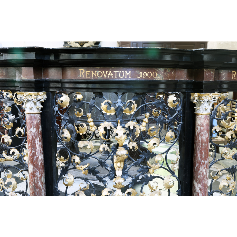 on the railing that surrounds the font