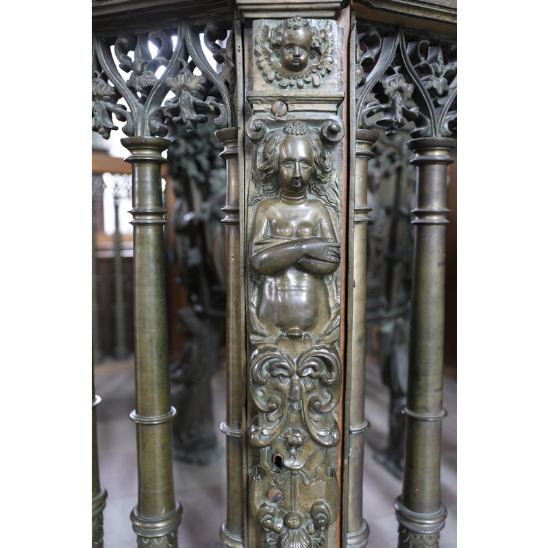 part of the railing that encloses the baptismal font