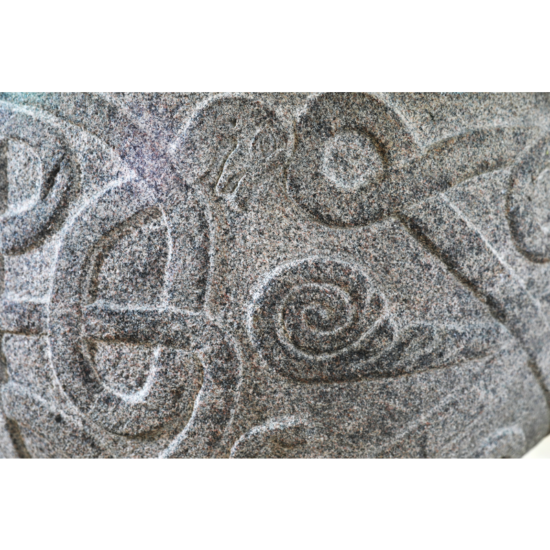 showing one of the snake heads and a snail shell below