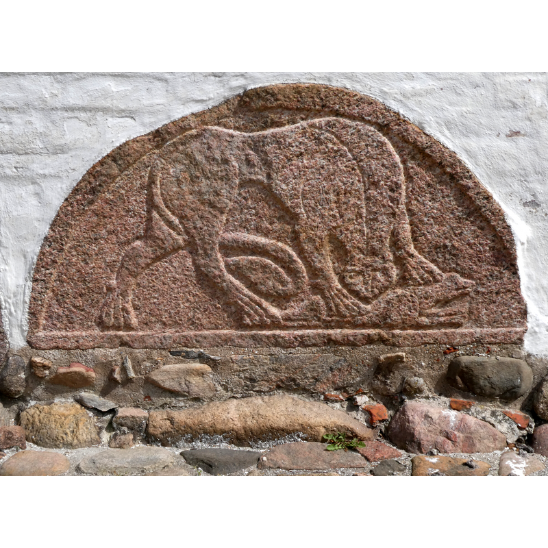 Poul Nørlund (1946) a source quoted in the DK entry for this church reckoned that this granite tympanum could not have originated in this church, as the building is not made of granite but of a different stone ["fraadsten"]; another source, Otto Norn (1954), also cited in the DK entry, however, stated that the  tympanum had sat above the south door of this church ["at tympanet havde siddet over kirkens syddør"]