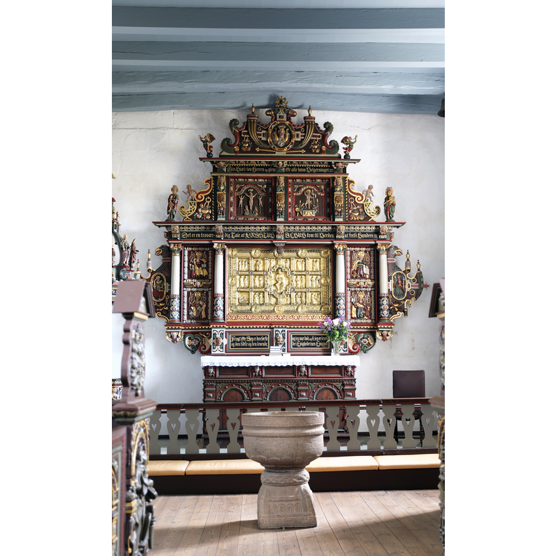 showing the medieval font at tghe east end of the nave