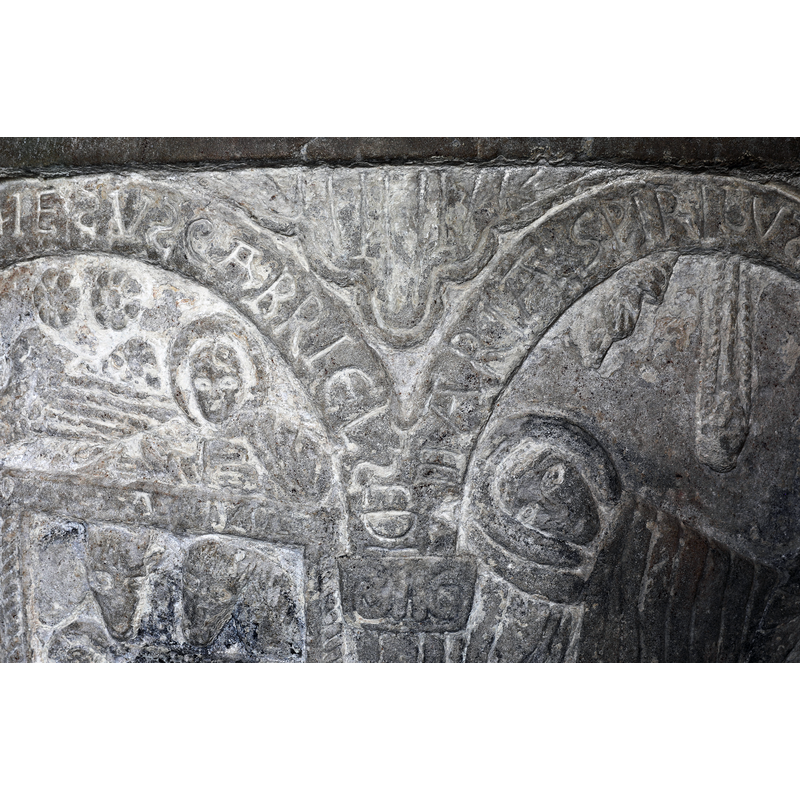 showing the spandrel and the top of the inscribed arch-heads that include the Nativity scene