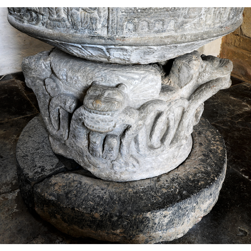 showing the animals biting the body of the snake thta loops all around, the drain opening on the base; showing also the flat-rib pattern around the underbowl