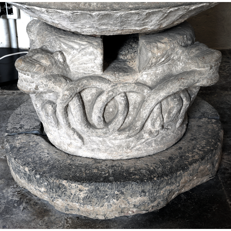 showing the animals biting the body of the snake thta loops all around, the drain opening on the base; showing also the flat-rib pattern around the underbowl