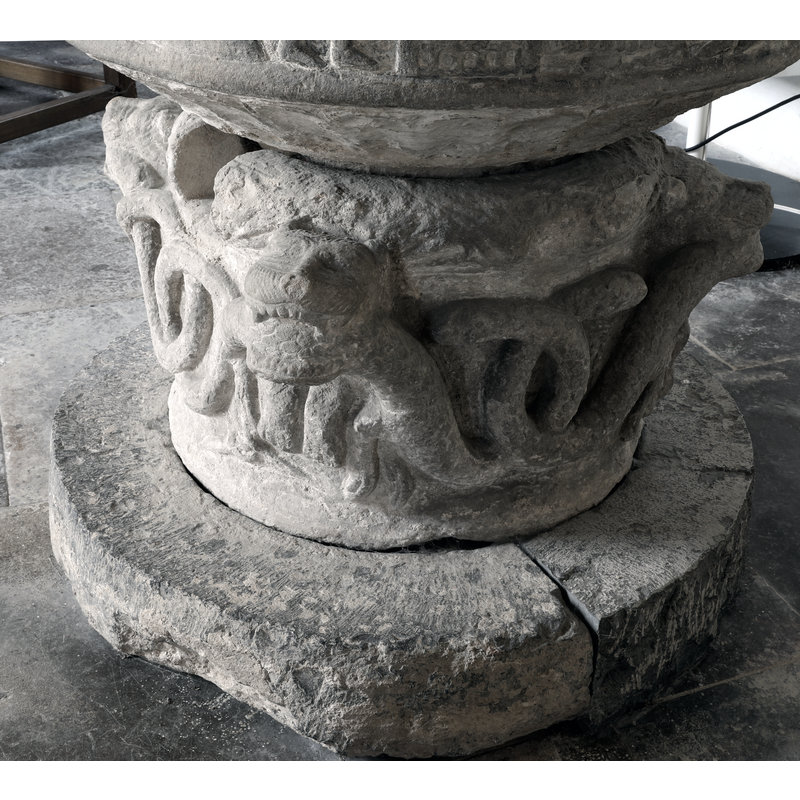 showing the animals biting the body of the snake thta loops all around, the drain opening on the base; showing also the flat-rib pattern around the underbowl