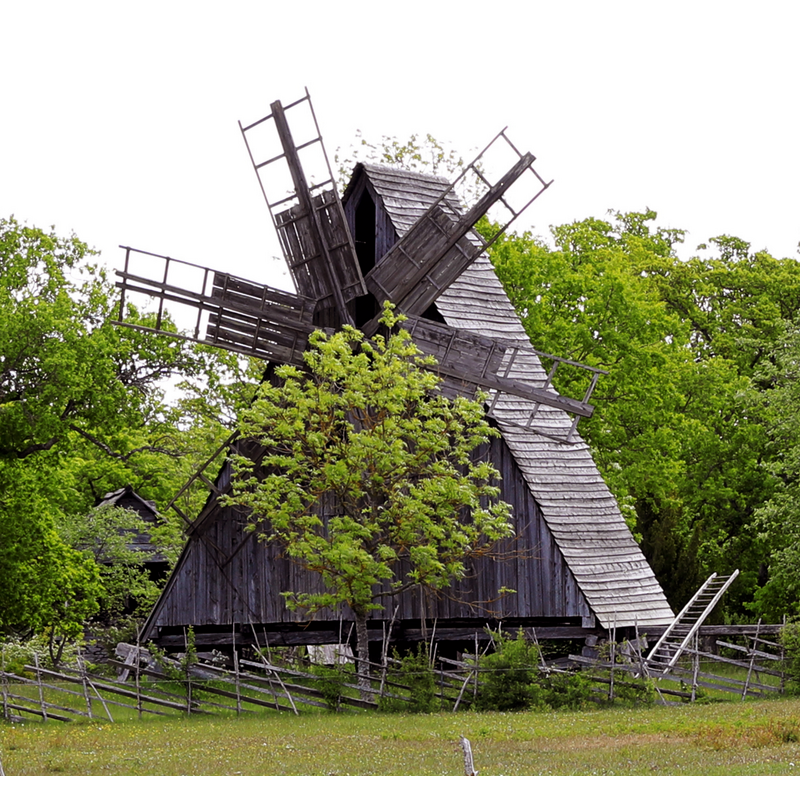 showing a disused old wooden windmill near the church grounds