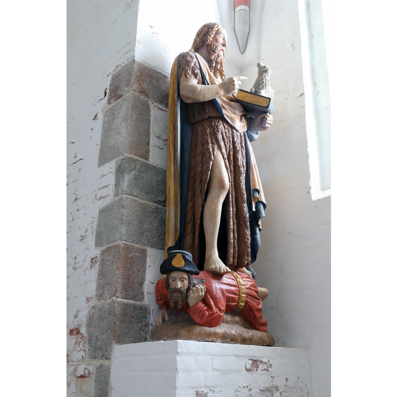 a John the Baptist wearu=ing skins stands on a recumbent James the Greater dressed in pilgrim garb